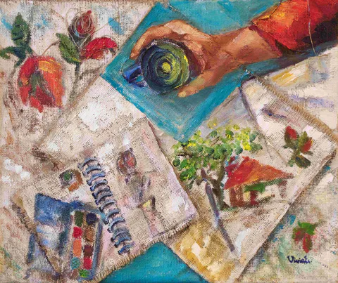 A hand holds a blue cup above a textured collage of sketchbook pages, painted roses, a paint box and a tiny red-roofed house.
