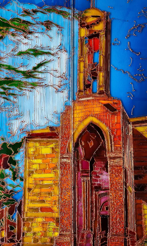 A pale green tree with copper-coloured branches stands beside a church whose pointed tower glows in orange and yellow against blue